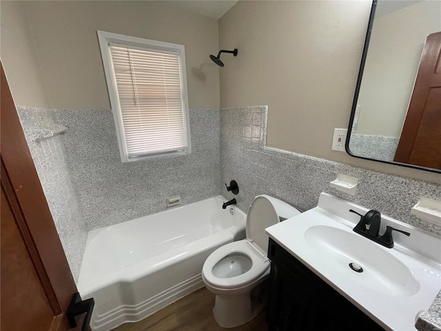 bathroom with shower / tub combination, toilet, a wainscoted wall, vanity, and tile walls