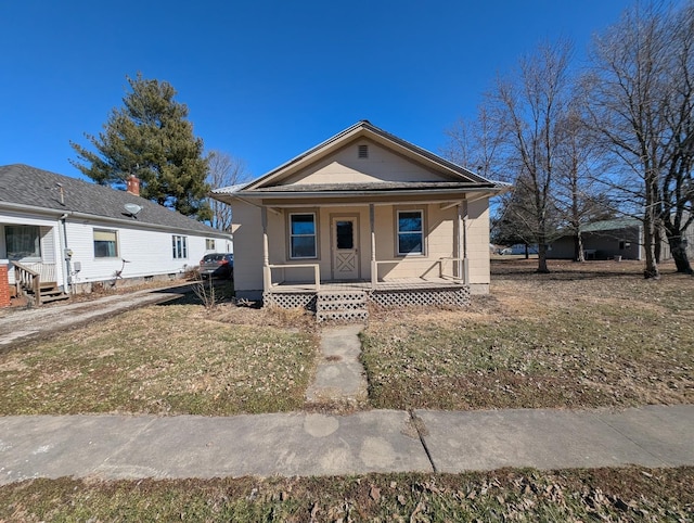 view of front of property featuring covered porch and a front yard