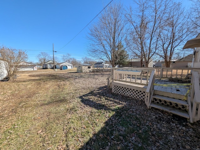 view of yard with fence and a wooden deck