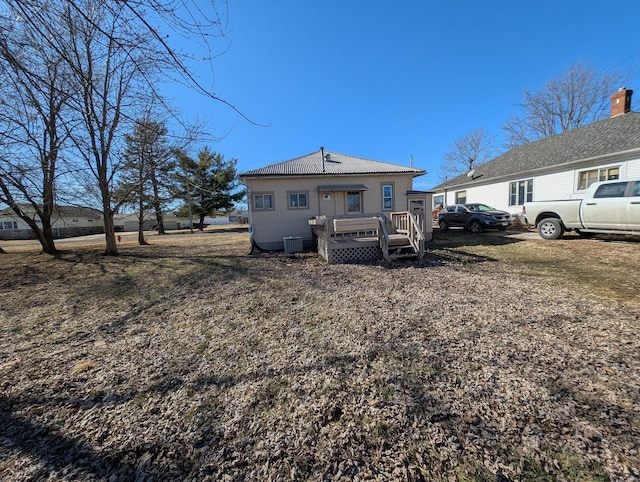 back of house with a wooden deck