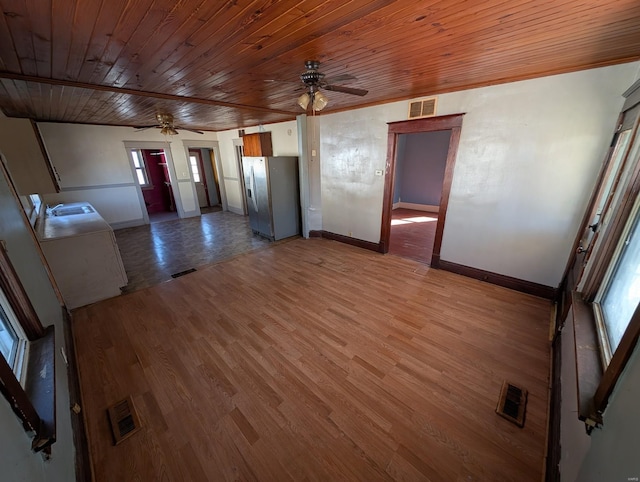 interior space featuring ceiling fan, visible vents, and light wood-style floors