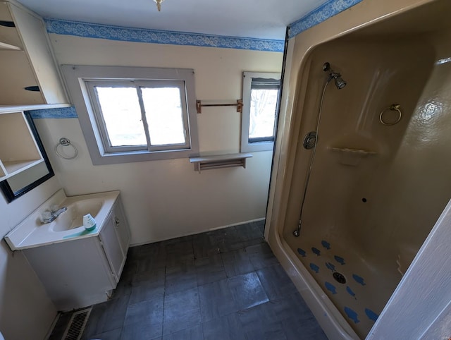 full bathroom with a stall shower and vanity