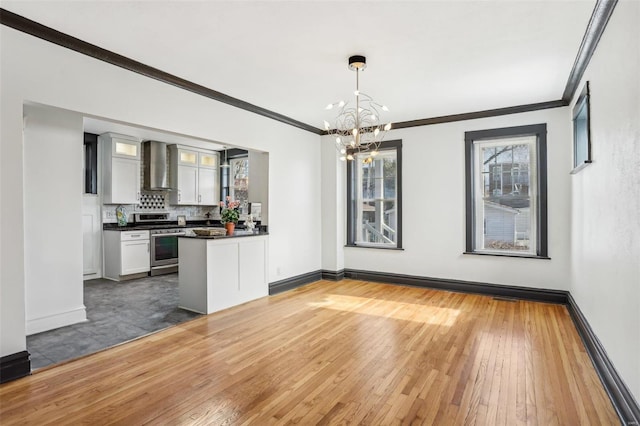 unfurnished dining area with hardwood / wood-style flooring and baseboards