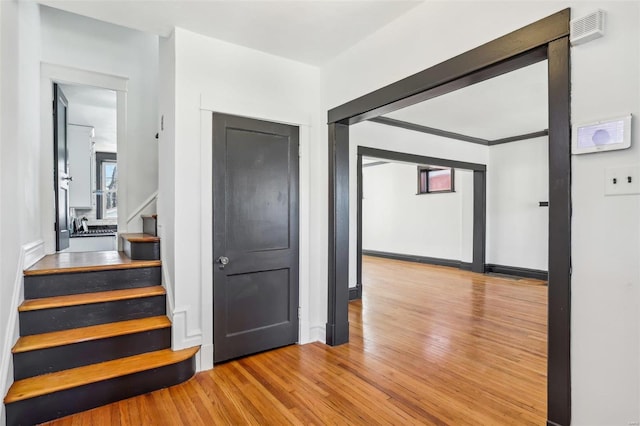 interior space with baseboards, stairway, and wood finished floors