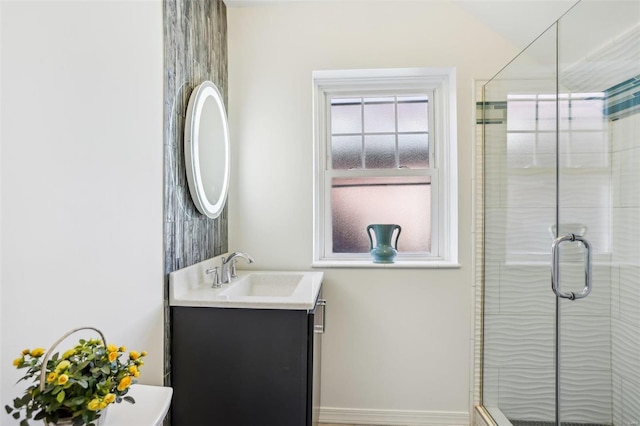 full bath with a stall shower and vanity