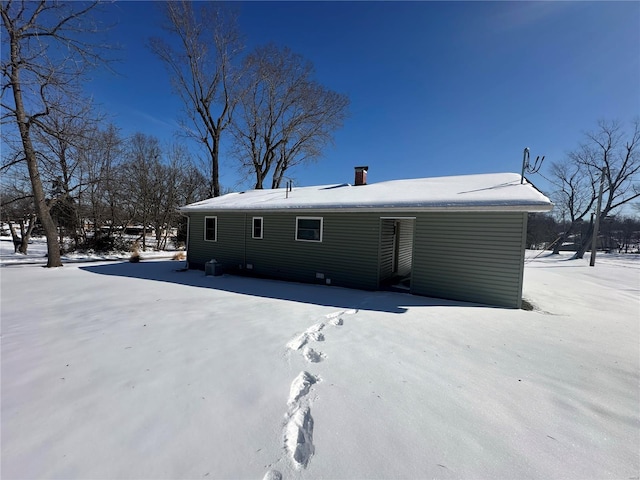 view of snow covered rear of property