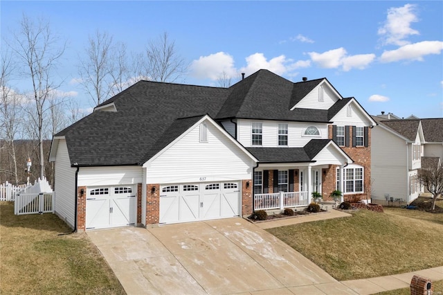 traditional-style house featuring a front yard, covered porch, brick siding, and fence