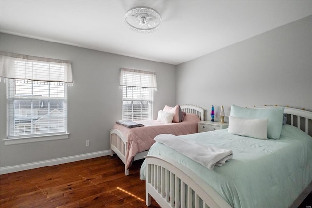 bedroom featuring dark wood-type flooring and baseboards