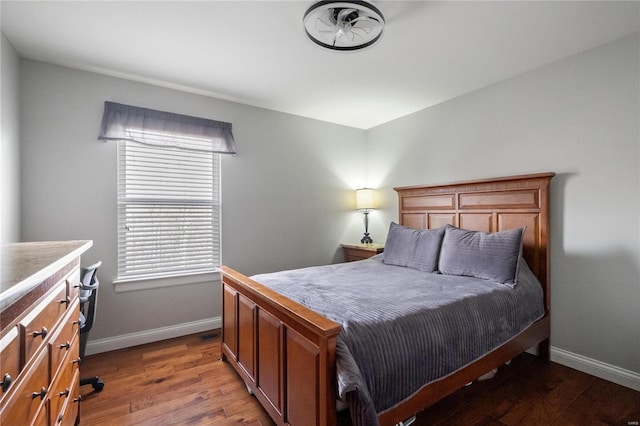 bedroom featuring baseboards and wood finished floors