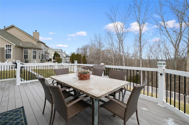 wooden deck with outdoor dining space and fence