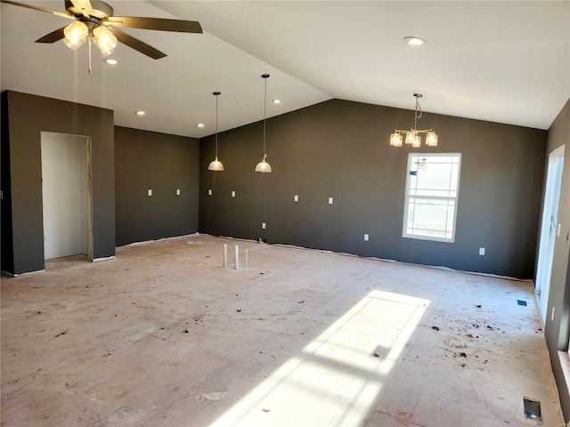 spare room with vaulted ceiling and ceiling fan with notable chandelier