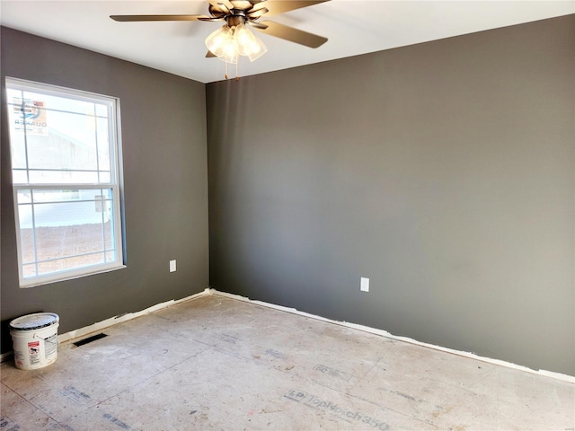 empty room featuring a ceiling fan and visible vents