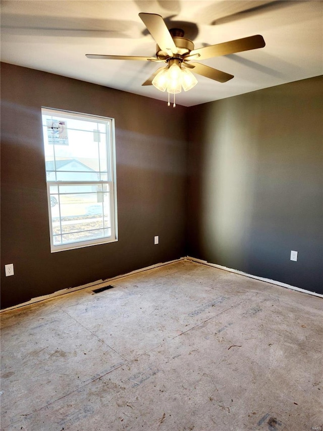 unfurnished room featuring visible vents and a ceiling fan