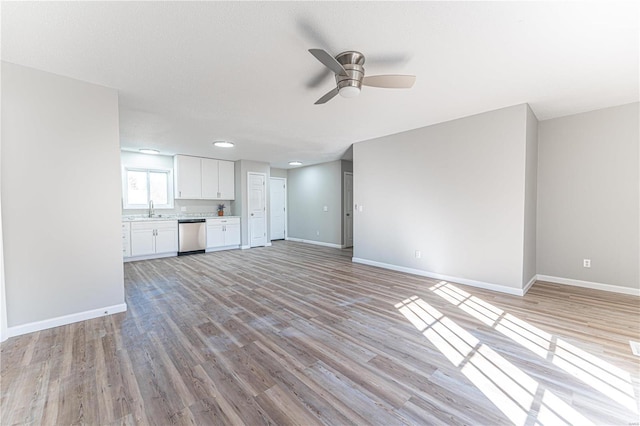 unfurnished living room featuring light wood-style floors and baseboards