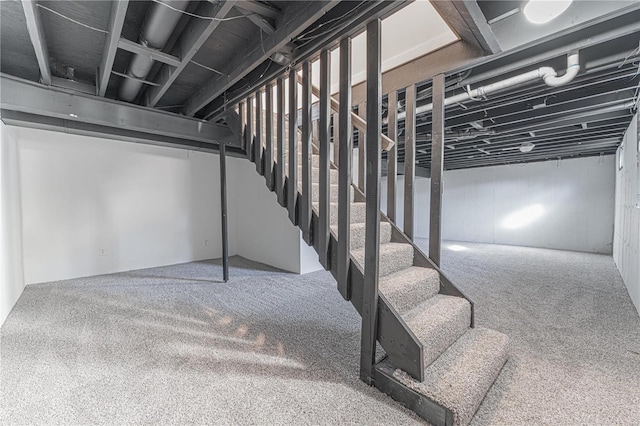 finished basement with stairs and carpet floors