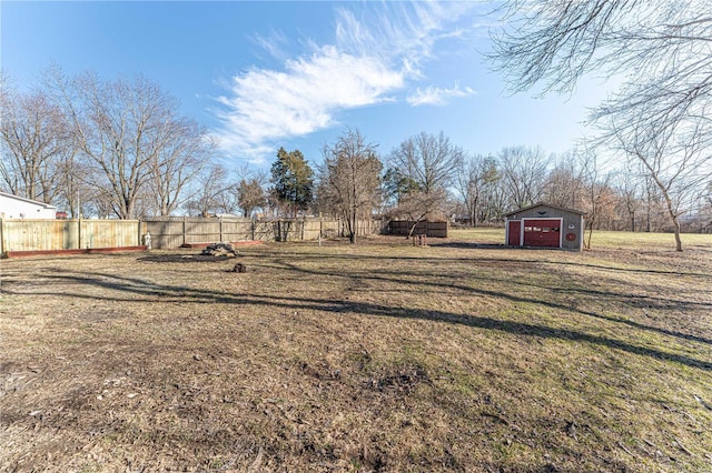 view of yard with fence and an outbuilding