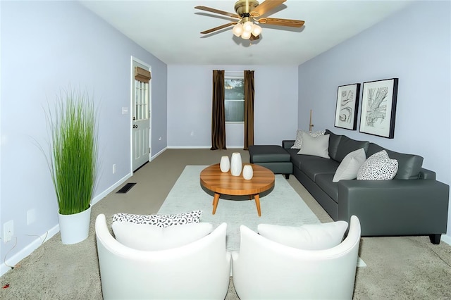 living room featuring baseboards, carpet flooring, visible vents, and a ceiling fan