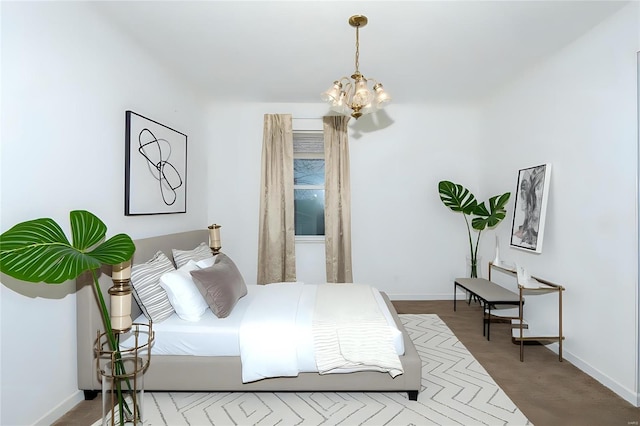 bedroom with a chandelier and baseboards