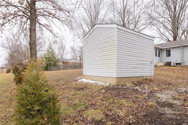 exterior space with central AC and fence