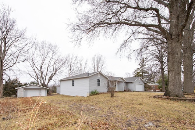 view of home's exterior with an outbuilding and a detached garage