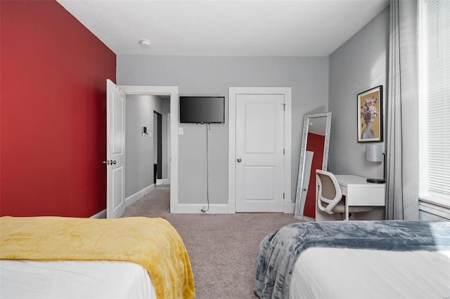 carpeted bedroom featuring baseboards