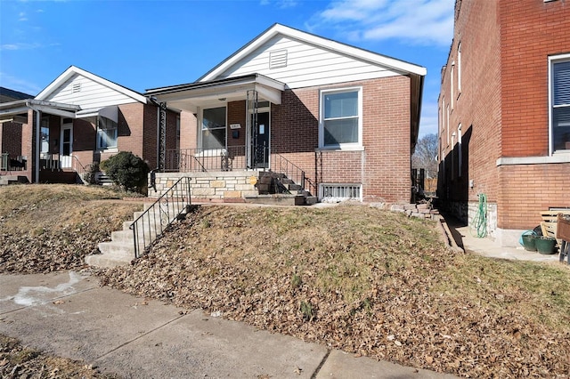 bungalow-style house with brick siding