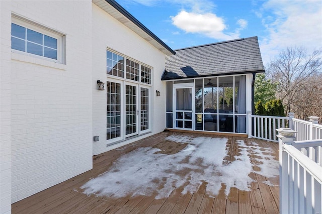 wooden deck featuring a sunroom