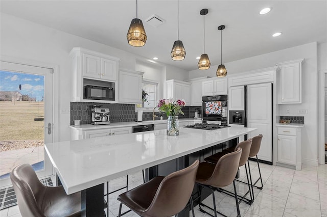 kitchen featuring black appliances, marble finish floor, decorative backsplash, and light countertops