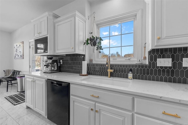 kitchen with tasteful backsplash, dishwasher, marble finish floor, white cabinetry, and a sink