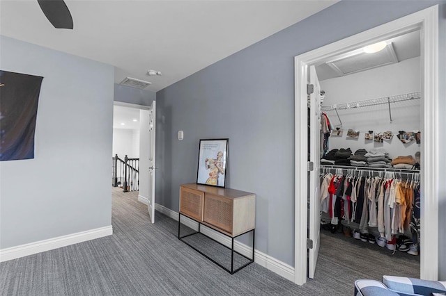 corridor featuring carpet flooring, visible vents, an upstairs landing, baseboards, and attic access