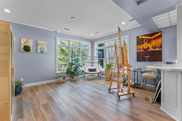 living area with recessed lighting, wood finished floors, visible vents, baseboards, and crown molding