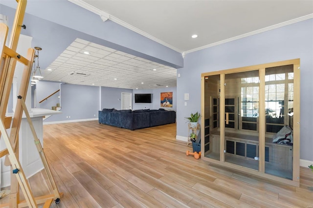 living room featuring crown molding, recessed lighting, wood finished floors, baseboards, and stairs