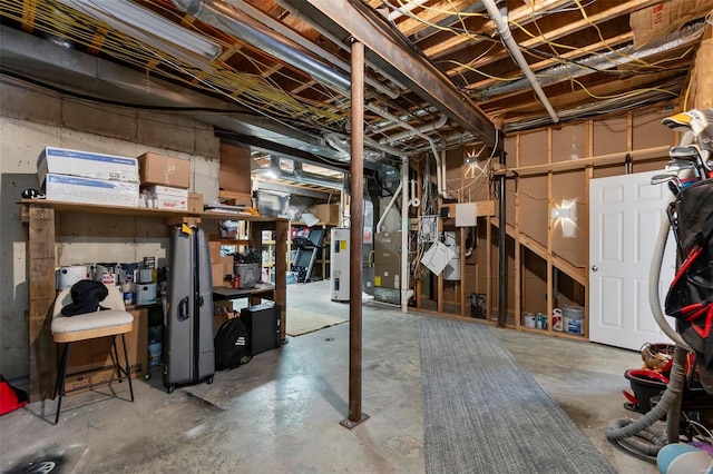 unfinished basement featuring water heater and heating unit