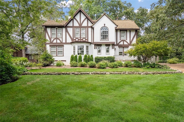 back of property with a lawn and stucco siding