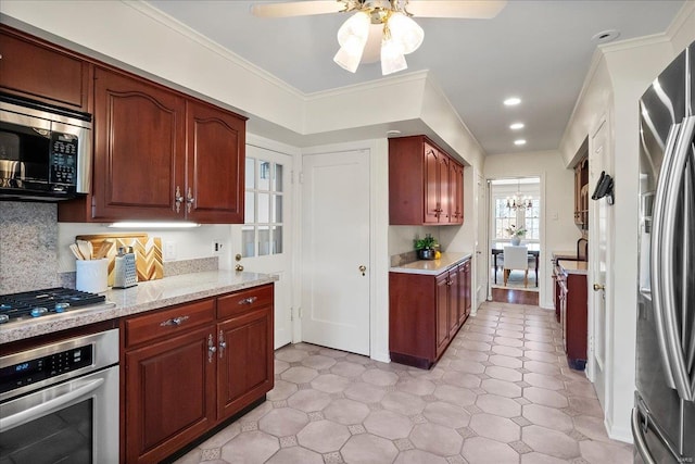 kitchen featuring stainless steel appliances, recessed lighting, backsplash, ornamental molding, and ceiling fan with notable chandelier