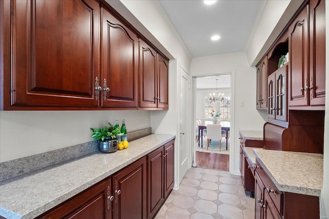 kitchen featuring light countertops, recessed lighting, an inviting chandelier, and crown molding