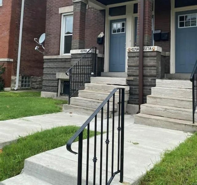 doorway to property with brick siding