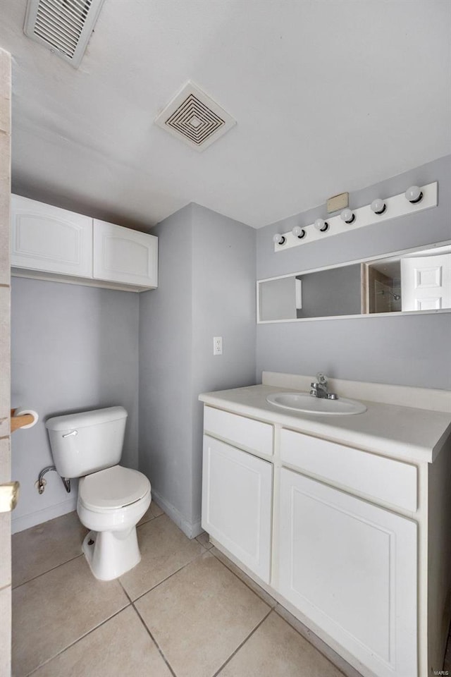 bathroom with toilet, vanity, visible vents, and tile patterned floors