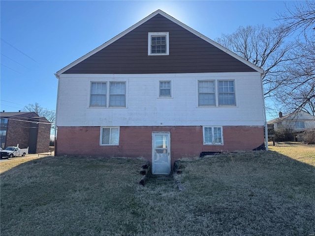 view of property exterior featuring a yard and brick siding