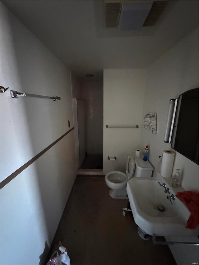 bathroom featuring a stall shower and toilet