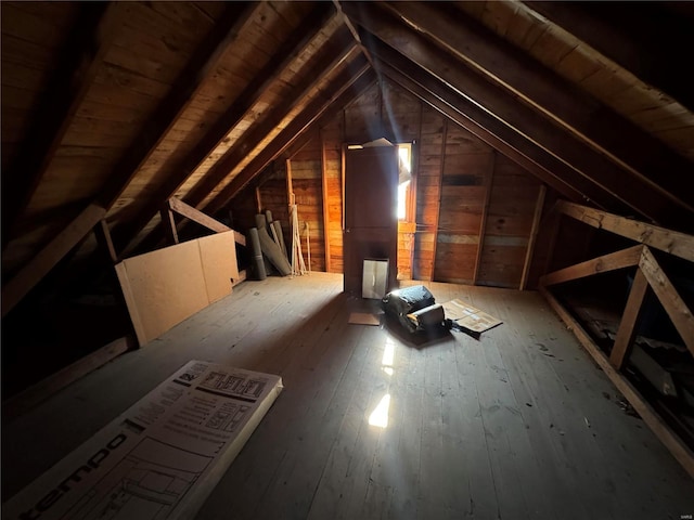 unfinished attic with an upstairs landing