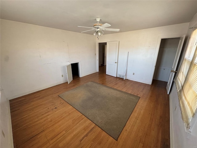 bedroom with a ceiling fan, visible vents, and wood finished floors