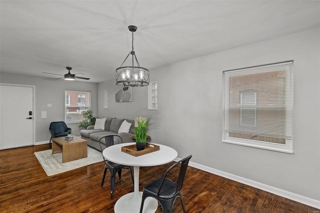 dining room with a ceiling fan, baseboards, and wood finished floors