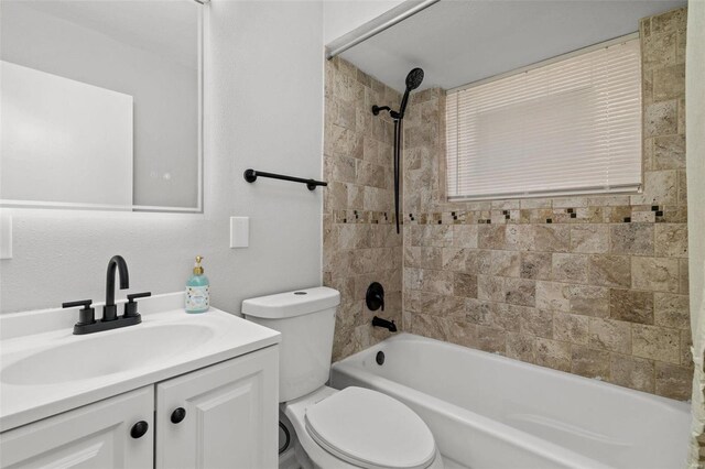 full bath with  shower combination, vanity, and toilet