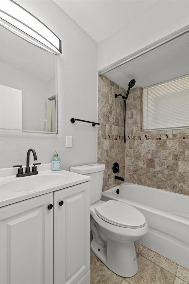 bathroom with toilet, shower / bath combination with curtain, and vanity