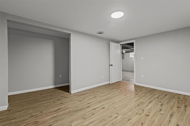 interior space featuring wood finished floors, visible vents, and baseboards