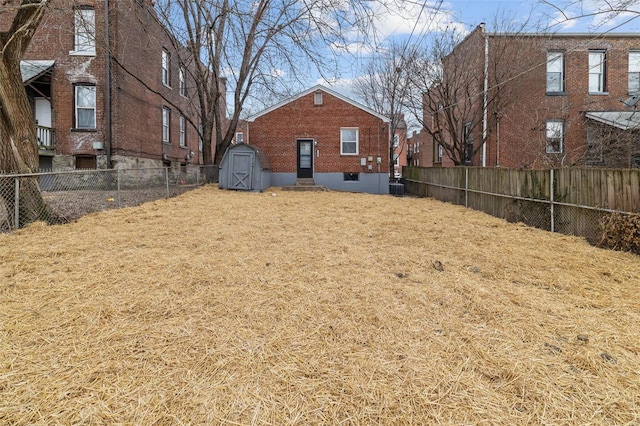 view of yard with a shed, an outdoor structure, and a fenced backyard