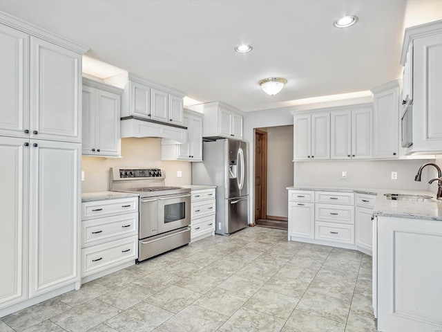 kitchen featuring under cabinet range hood, a sink, white cabinets, appliances with stainless steel finishes, and light stone countertops