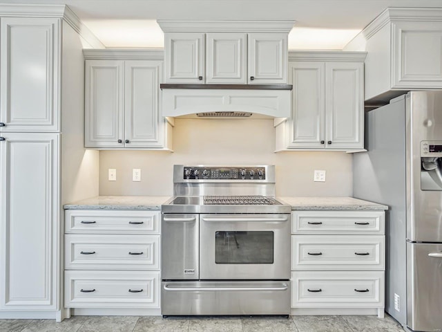 kitchen with appliances with stainless steel finishes, custom exhaust hood, white cabinetry, and light stone countertops