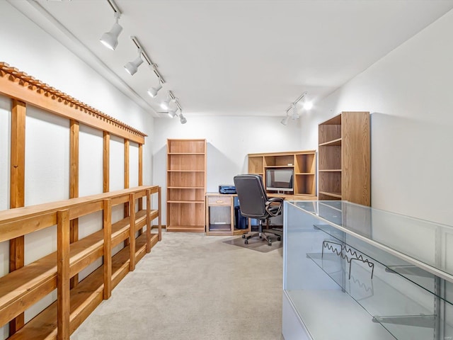 office area with track lighting and light colored carpet